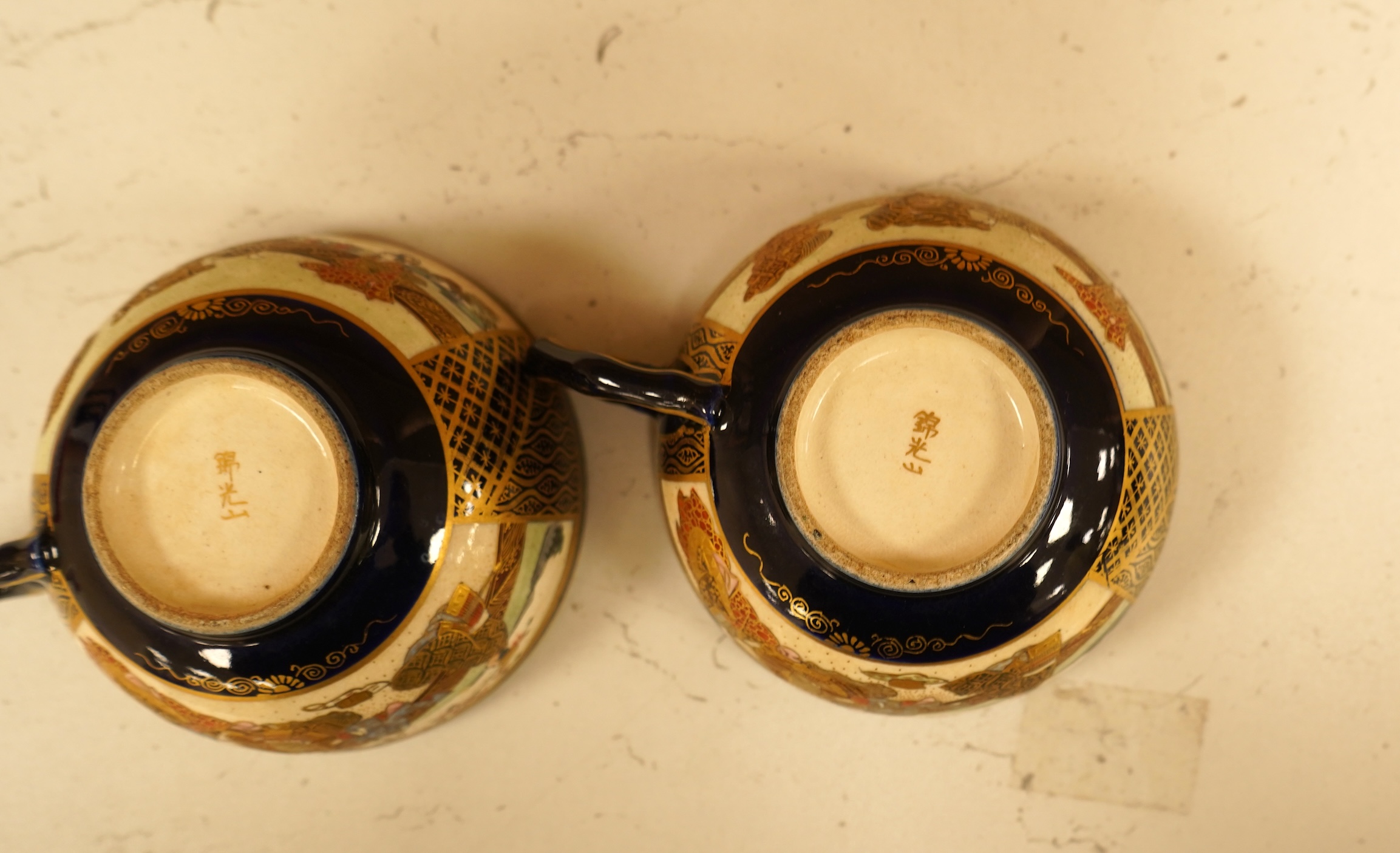 A set of six Japanese Satsuma pottery teacups and saucers, and two further saucers
